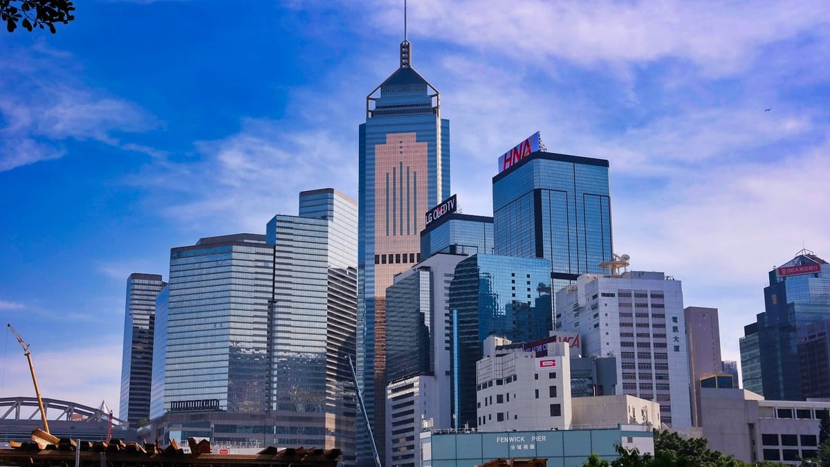 La skyline du quartier d'affaires de Central et Wan Chai à Hong Kong sous un ciel bleu — la base internationale de la société hongkongaise d'un consultant français